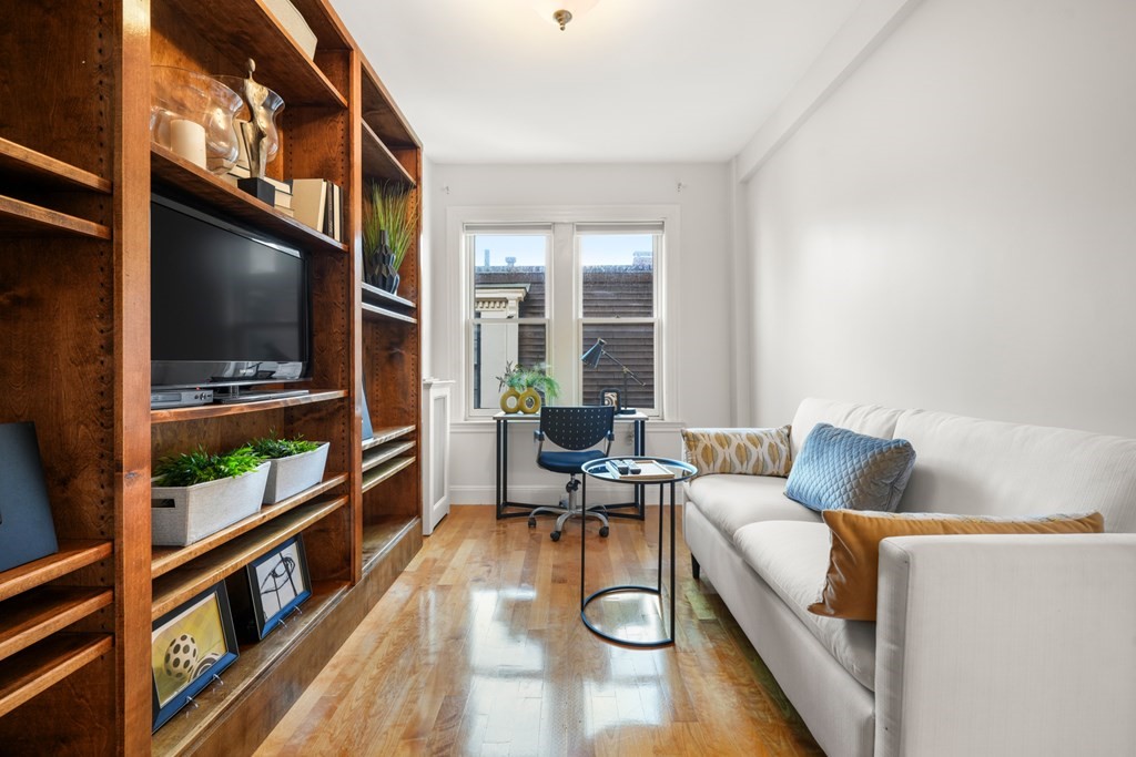 311 Commonwealth Avenue, Unit 41 Boston, MA 02115 - Photo 17 of 31 a living room with furniture and a flat screen tv