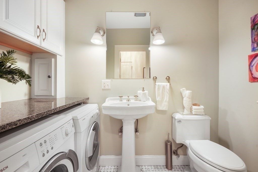 311 Commonwealth Avenue, Unit 41 Boston, MA 02115 - Photo 20 of 31 a bathroom with a sink a toilet and a mirror