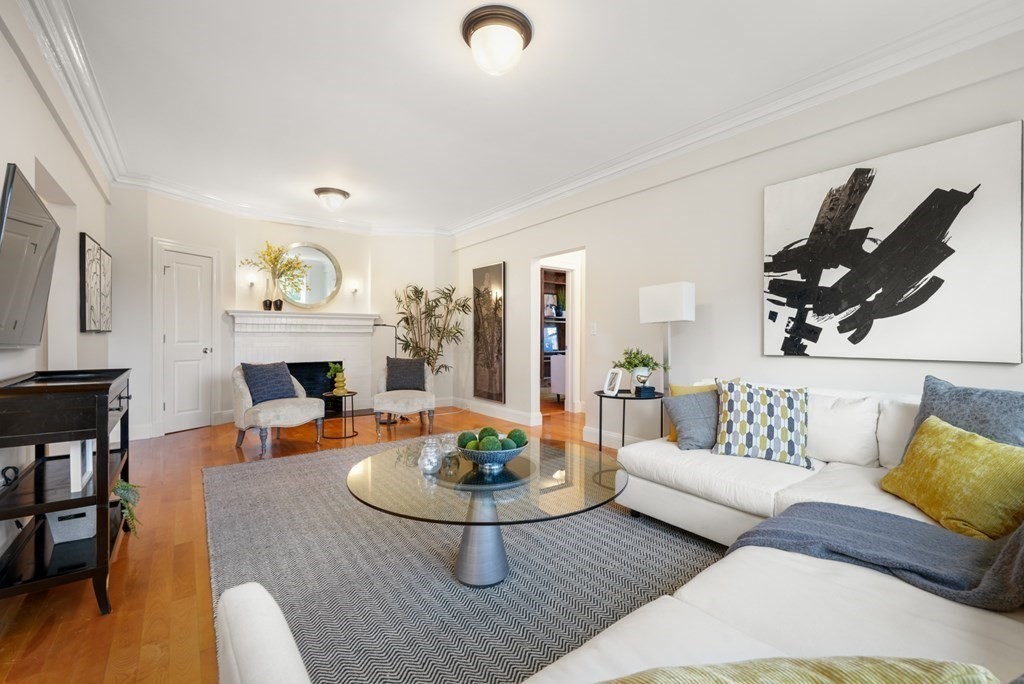 311 Commonwealth Avenue, Unit 41 Boston, MA 02115 - Photo 2 of 31 a living room with furniture and a fireplace