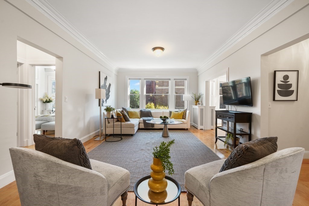 311 Commonwealth Avenue, Unit 41 Boston, MA 02115 - Photo 3 of 31 a living room with furniture and a flat screen tv