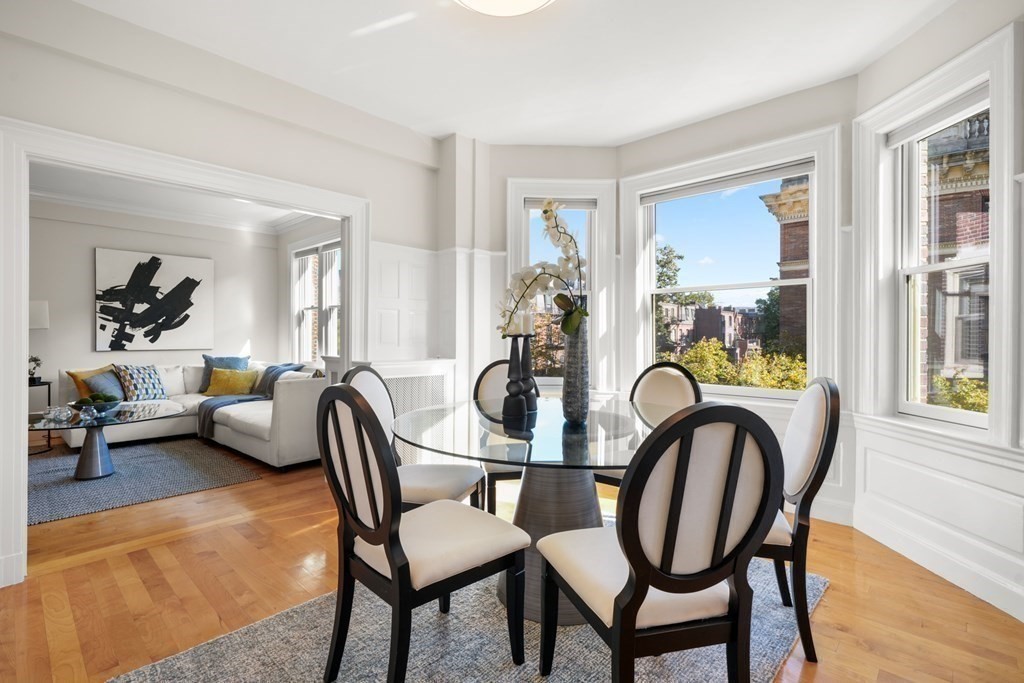 311 Commonwealth Avenue, Unit 41 Boston, MA 02115 - Photo 5 of 31 a dining room with furniture and a floor to ceiling window
