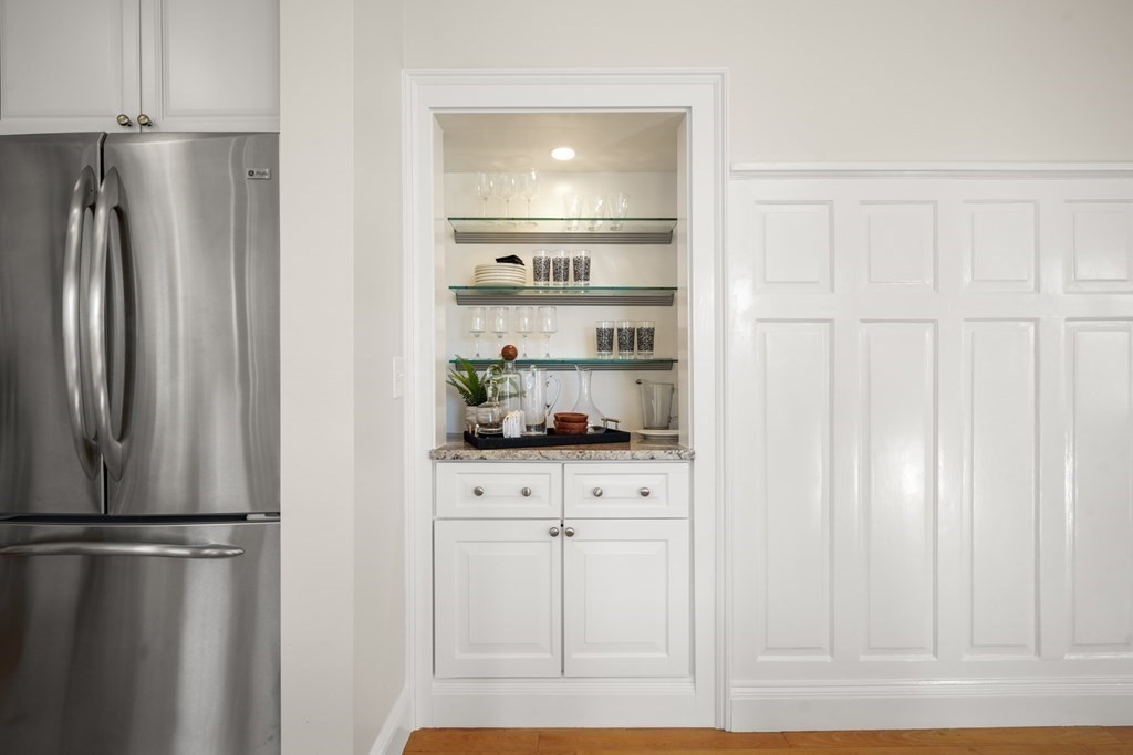 311 Commonwealth Avenue, Unit 41 Boston, MA 02115 - Photo 9 of 31 a kitchen with stainless steel appliances a refrigerator and cabinets
