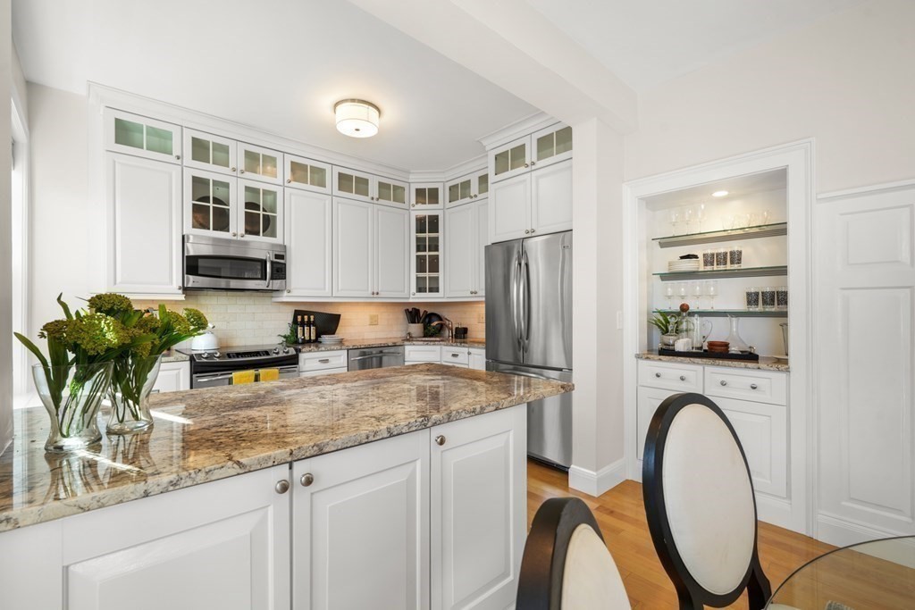 311 Commonwealth Avenue, Unit 41 Boston, MA 02115 - Photo 10 of 31 a kitchen with stainless steel appliances granite countertop a refrigerator and a stove top oven
