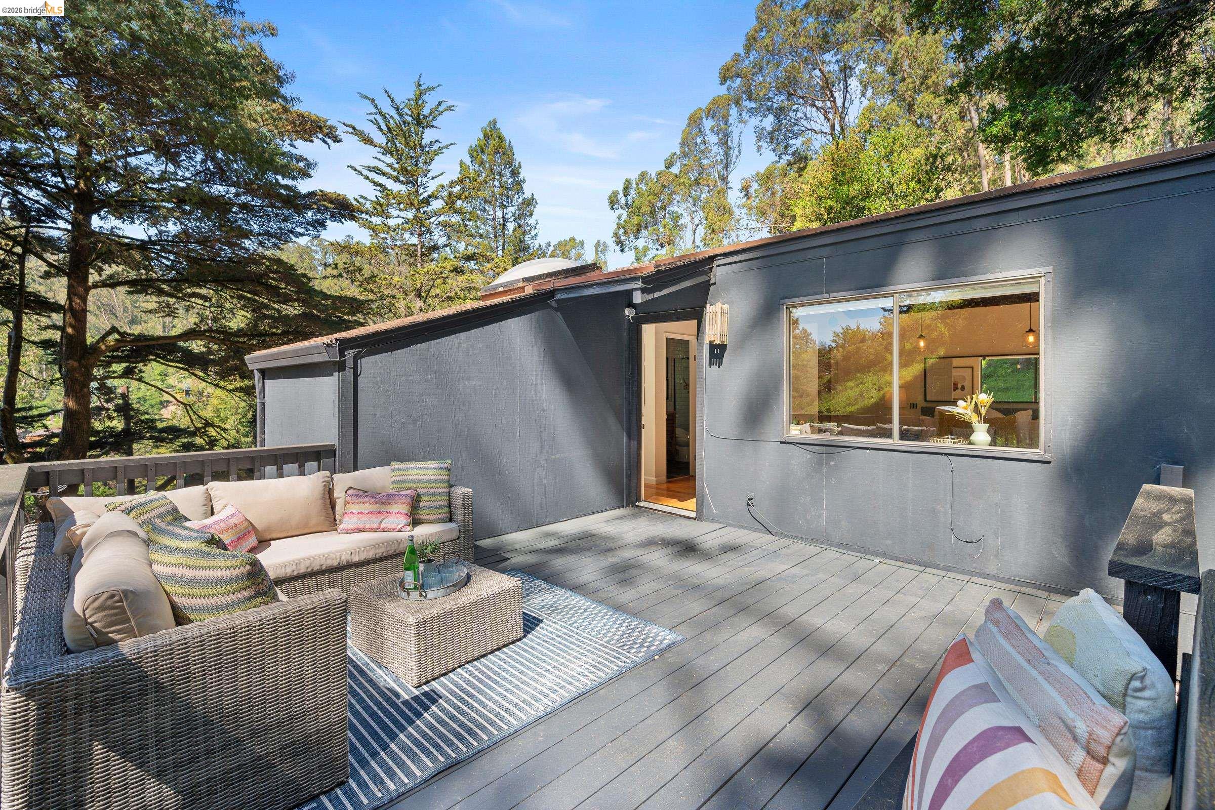 6600 Heather Ridge Way Oakland, CA 94611 - Photo 64 of 66 Expansive outdoor deck featuring composite decking and a dark gray exterior facade