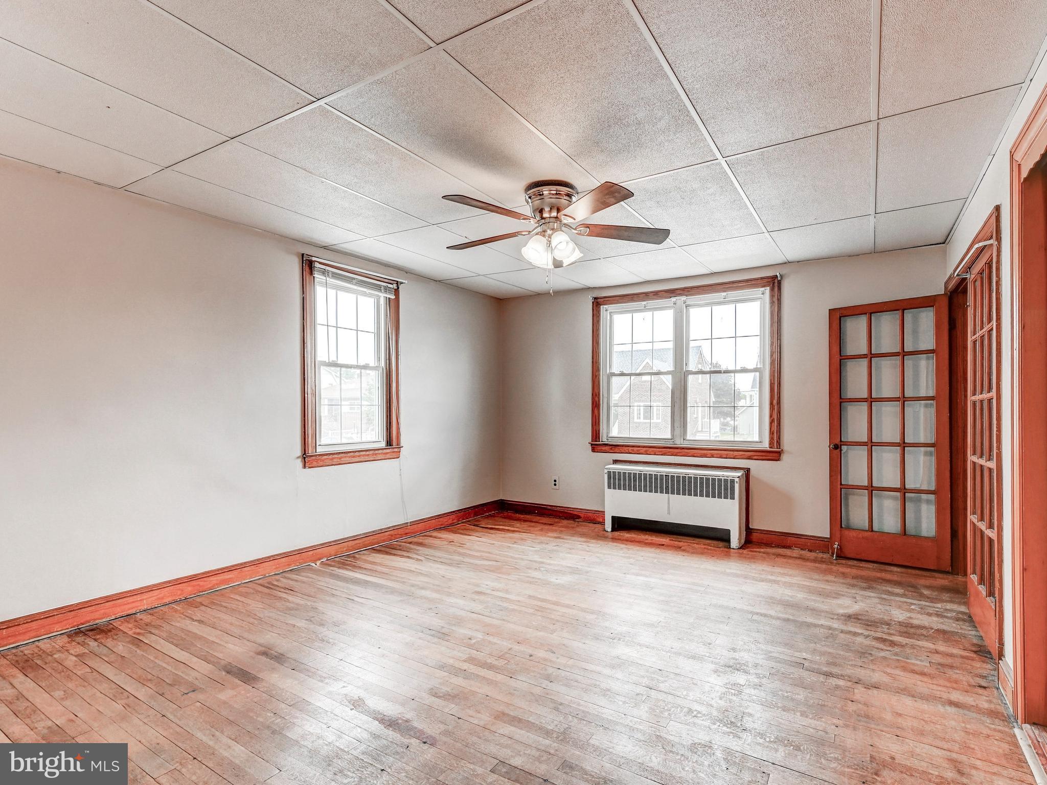 3206 Lynch Road Baltimore, MD 21219 - Photo 13 of 70 an empty room with windows and ceiling fan