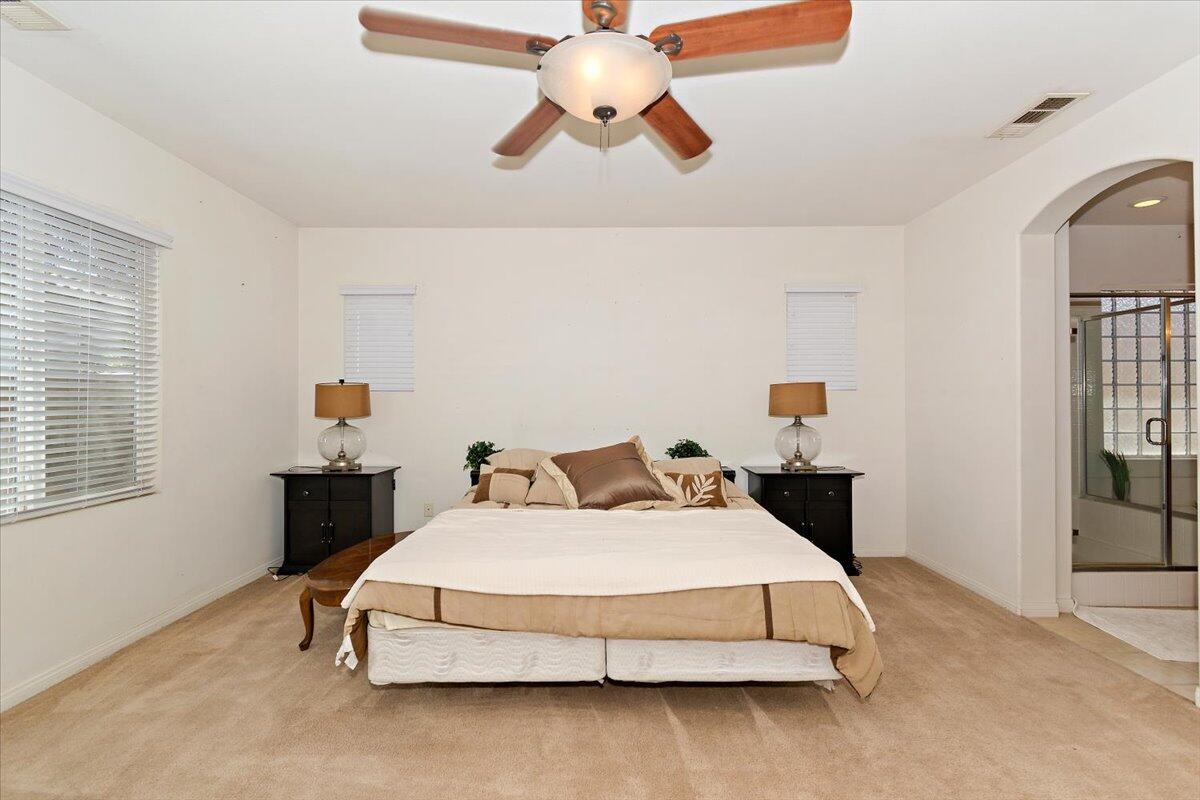 49528 Pacino Street Indio, CA 92201 - Photo 17 of 22 a bedroom with a bed and window