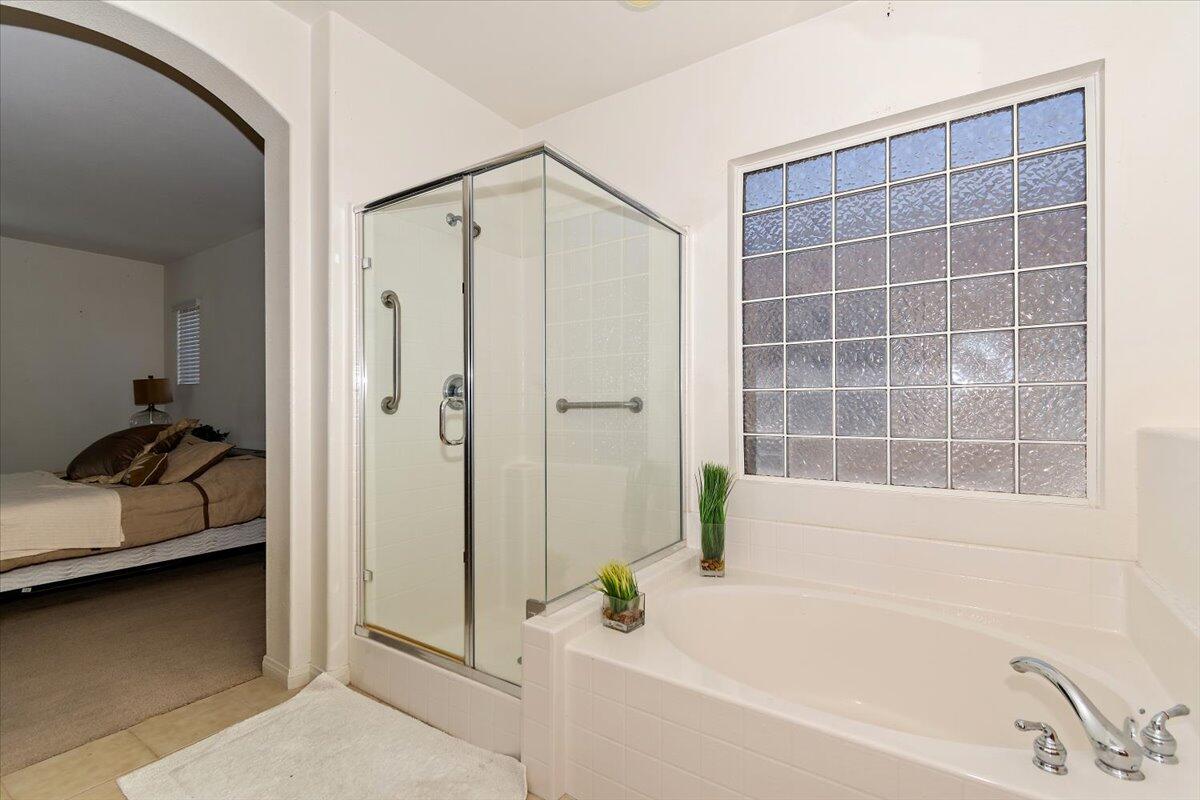 49528 Pacino Street Indio, CA 92201 - Photo 19 of 22 a bathroom with a tub and a shower