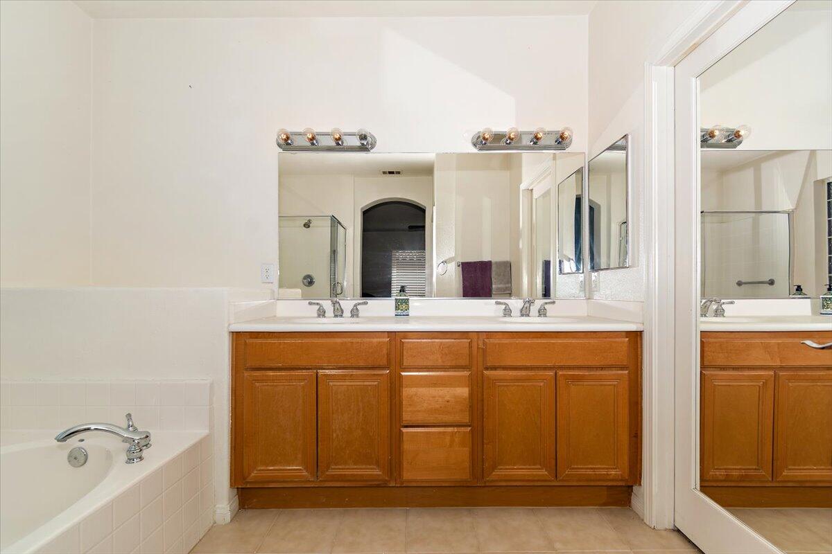 49528 Pacino Street Indio, CA 92201 - Photo 20 of 22 a bathroom with a tub sink and mirror
