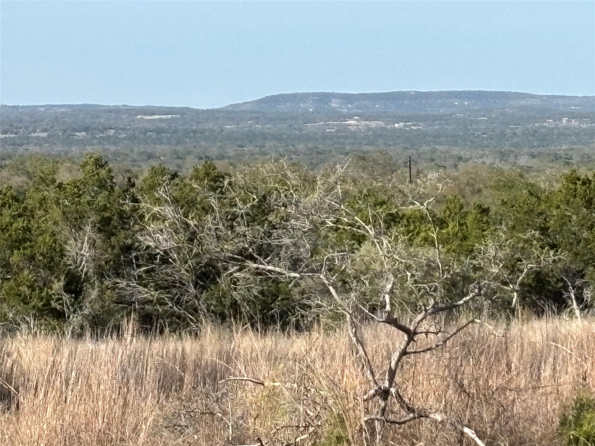 768 Tiswin Trail Blanco, TX 78606 - Photo 5 of 14 a view of a lake with a mountain in the background