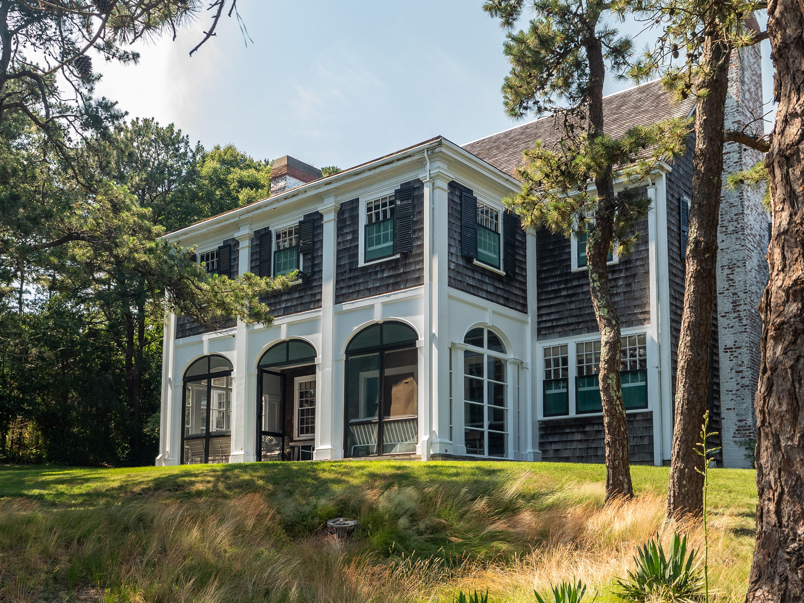 671 Old Post Road Cotuit, MA 02635 - Photo 27 of 36 a large building with a big yard and large trees