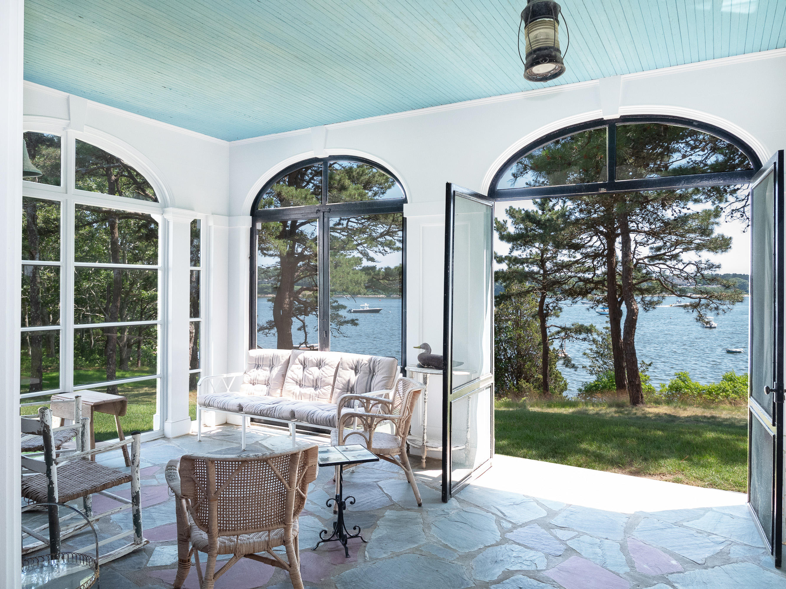 671 Old Post Road Cotuit, MA 02635 - Photo 6 of 36 a view of a porch with chairs and floor to ceiling window