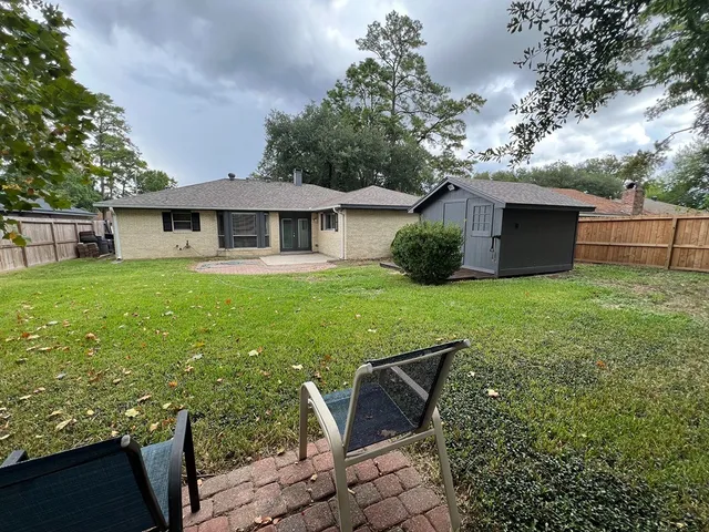 a view of a house with backyard sitting area and garden