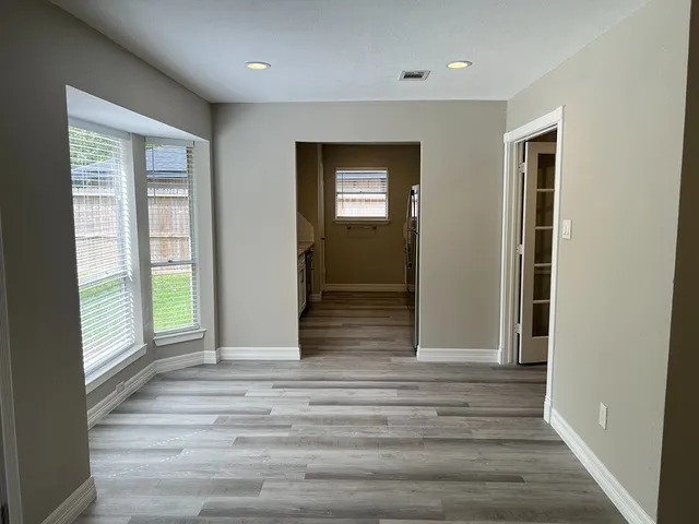 a view of room with window and wooden floor