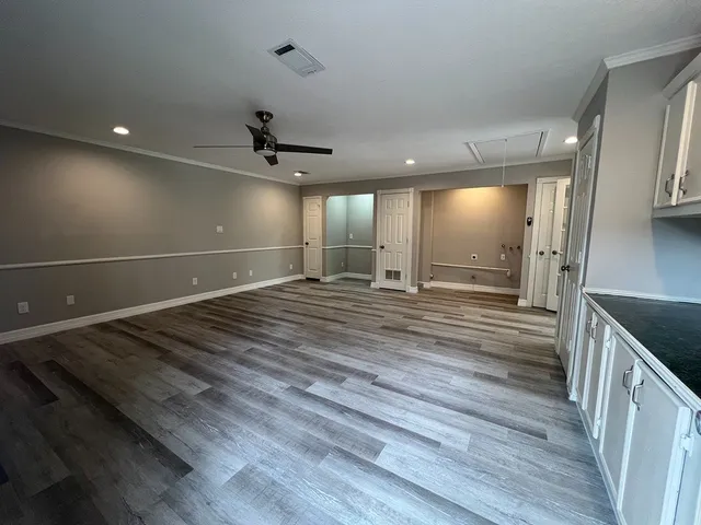 a view of a room with a sink and wooden floor