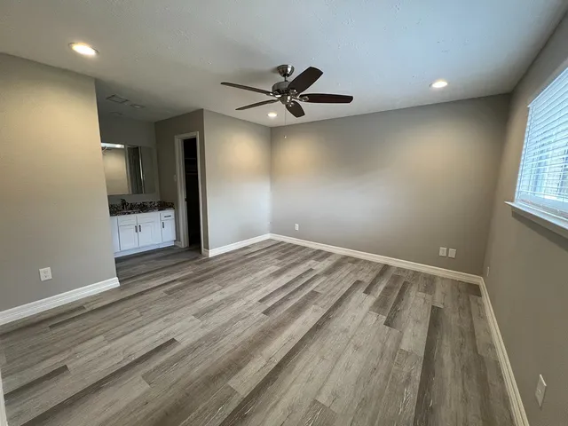 wooden floor in an empty room with a window