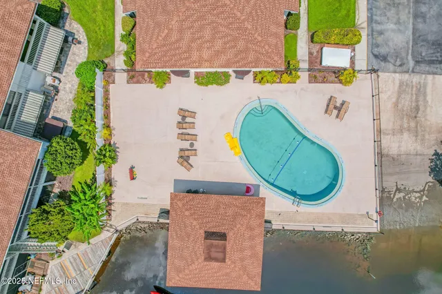 view of a swimming pool with a yard