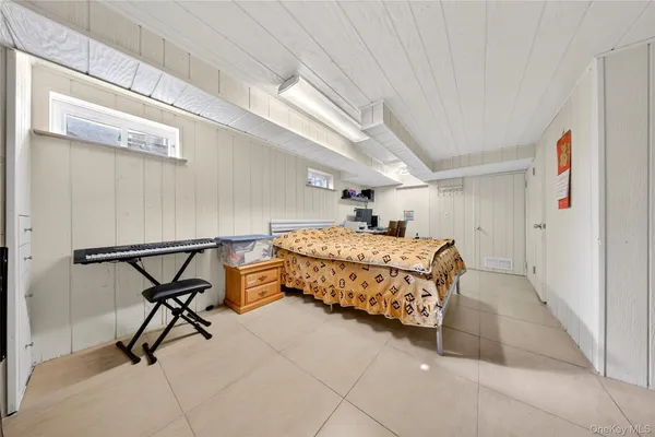 a bedroom with furniture and a window