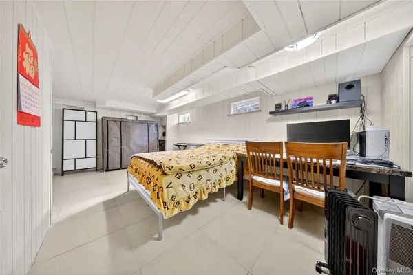 a bedroom with furniture and a window
