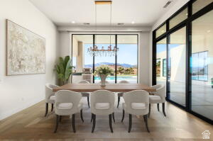 1141 East Lost Ridge Drive Washington, UT 84780 - Photo 48 of 108 Dining area featuring wood-finish flooring, a contemporary chandelier, recessed ceiling lighting, and expansive glass sliding doors