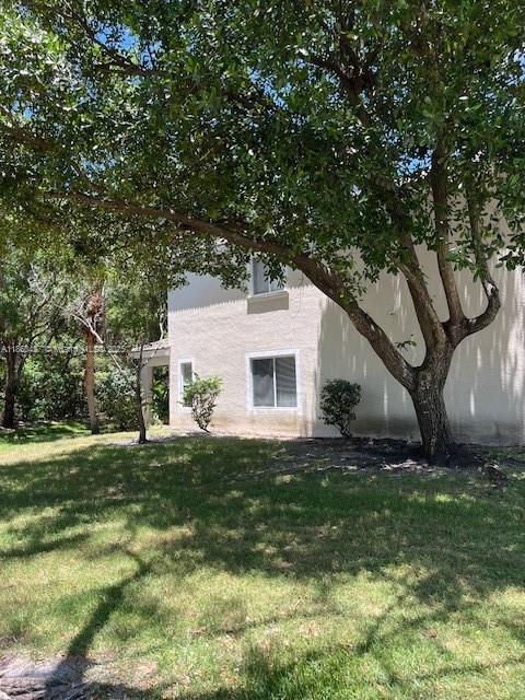 4619 Palmbrooke Circle, Unit 4619 West Palm Beach, FL 33417 - Photo 6 of 15 a backyard of a house with table and chairs