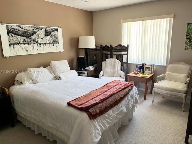 4619 Palmbrooke Circle, Unit 4619 West Palm Beach, FL 33417 - Photo 7 of 15 a bedroom with bed and a couch