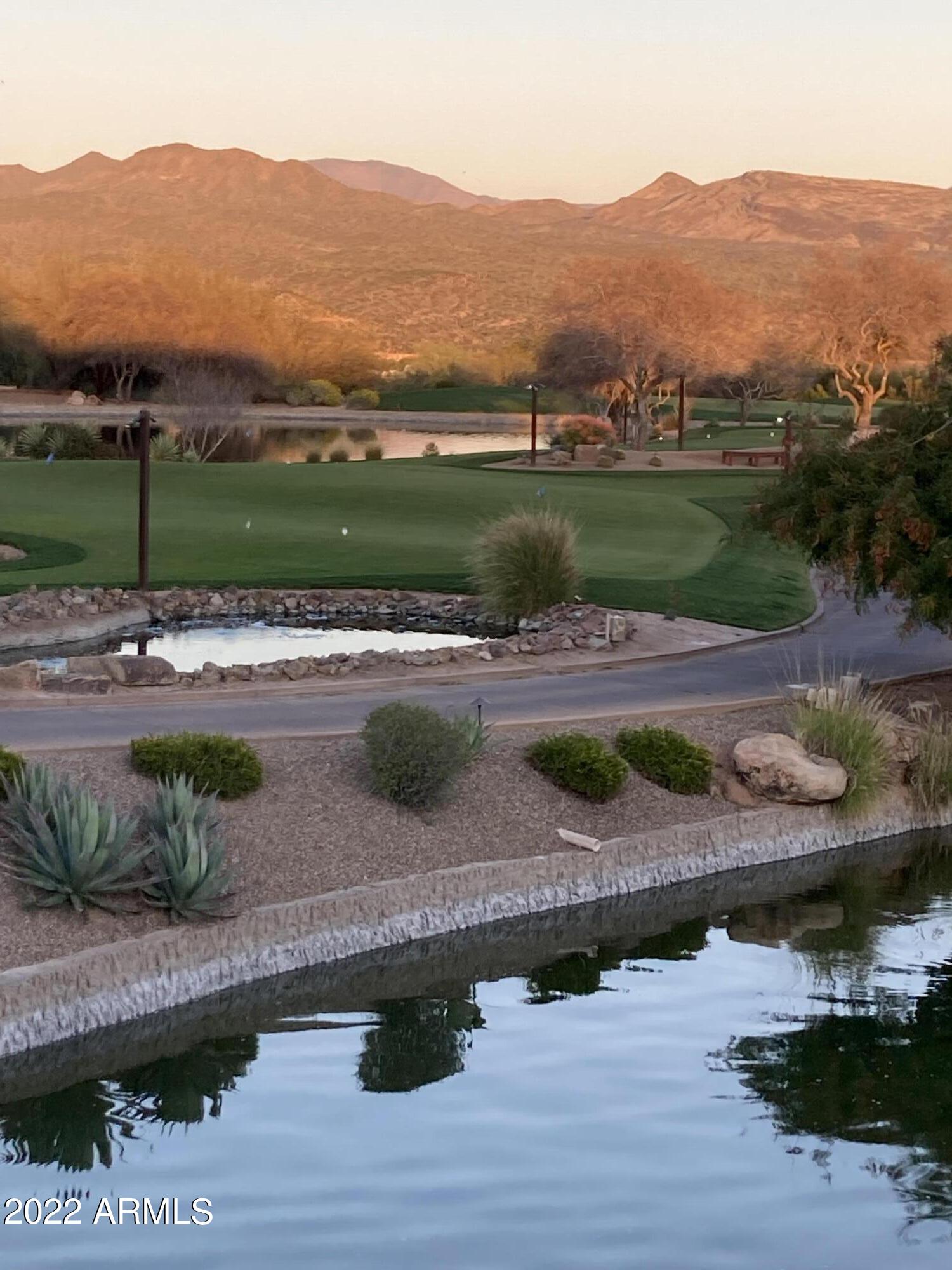 18400 Cobre Way Rio Verde, AZ 85263 - Photo 33 of 38 Clubhouse view of lake/course at sunset