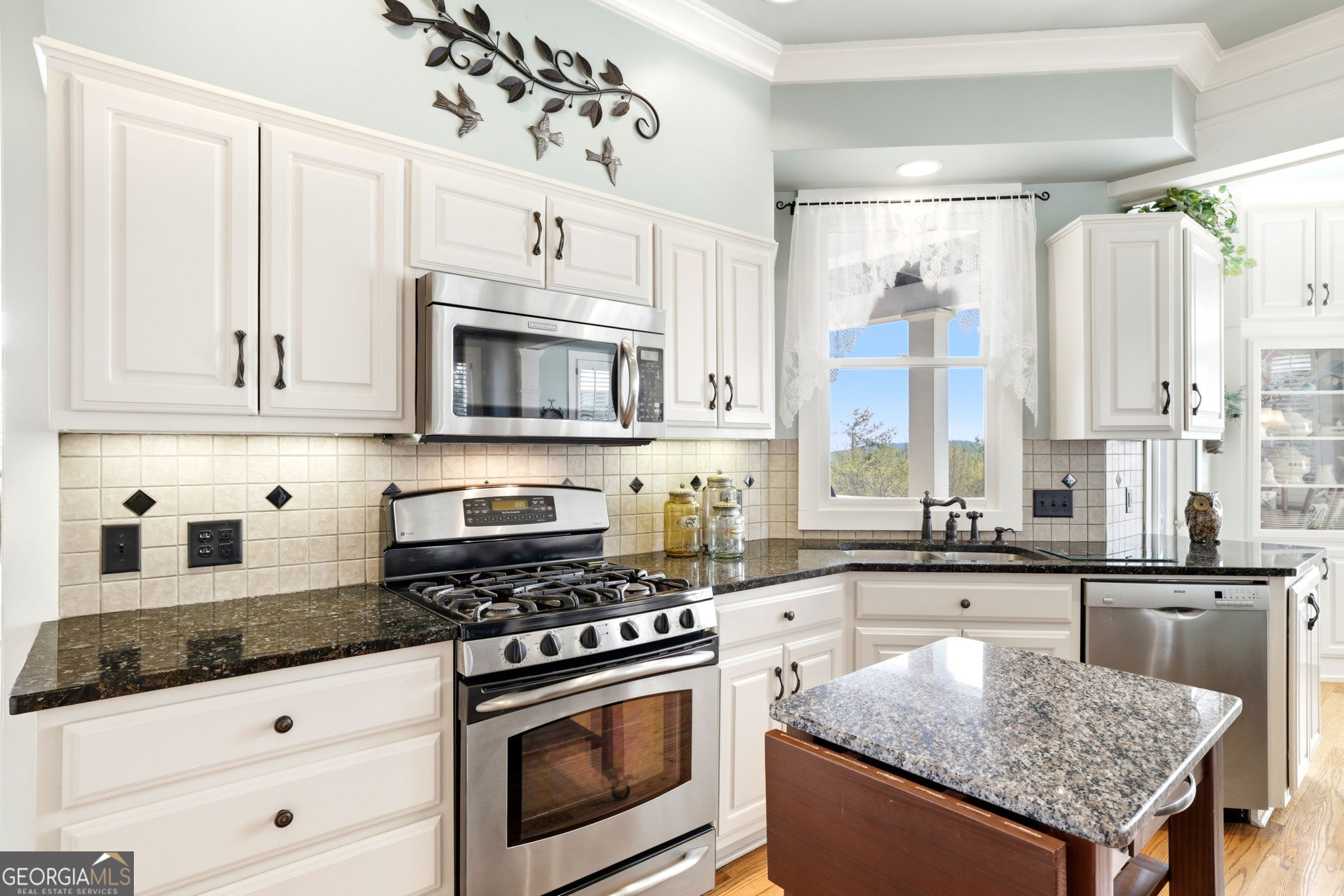 1171 Rabun Bluffs Drive Lakemont, GA 30552 - Photo 16 of 75 a kitchen with stainless steel appliances granite countertop a stove a sink and a microwave