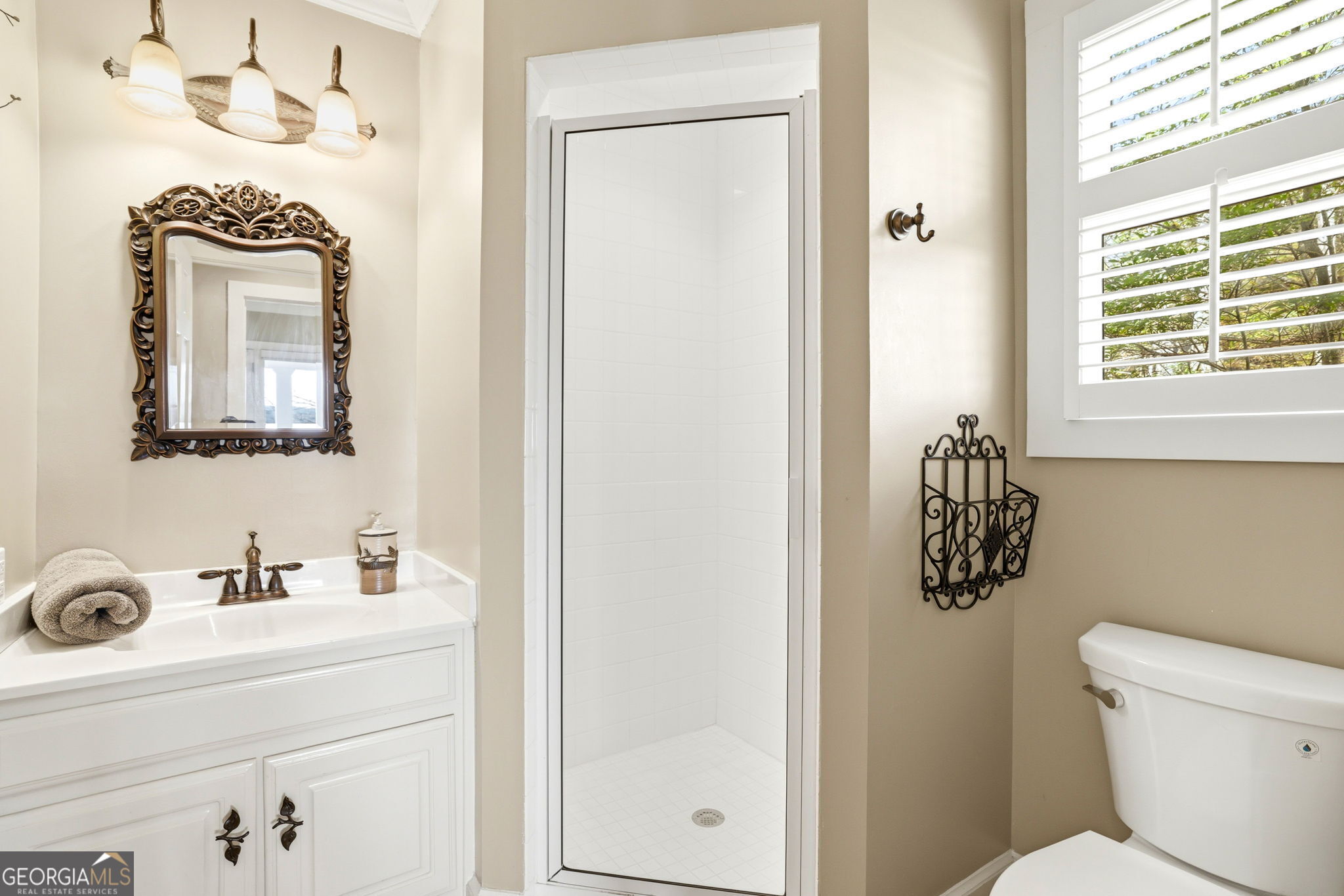 1171 Rabun Bluffs Drive Lakemont, GA 30552 - Photo 27 of 75 a bathroom with a toilet a sink a mirror and a window