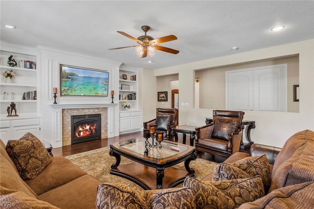 9910 Copenhagen Way Reno, NV 89521 - Photo 4 of 22 a living room with furniture a fireplace and a flat screen tv