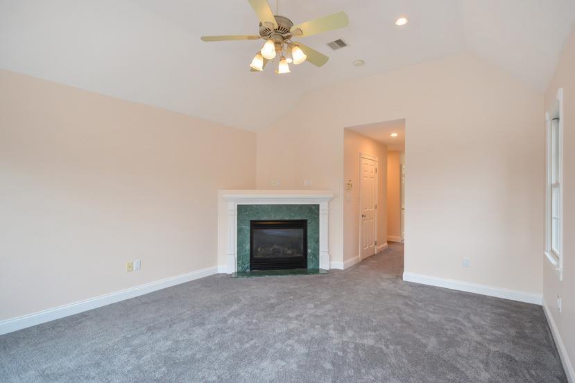 113 James Circle Mashpee, MA 02649 - Photo 11 of 29 a view of a livingroom with a fireplace and chandelier fan