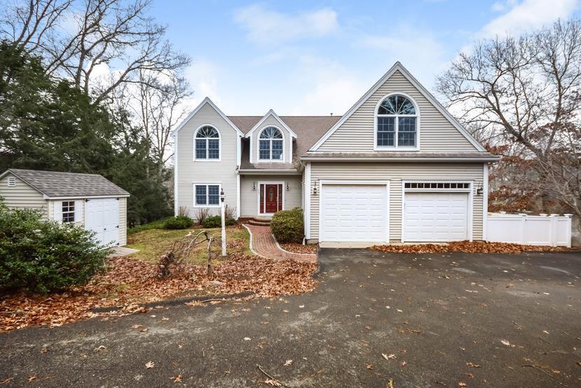 113 James Circle Mashpee, MA 02649 - Photo 2 of 29 a view of a white house with a yard and large tree