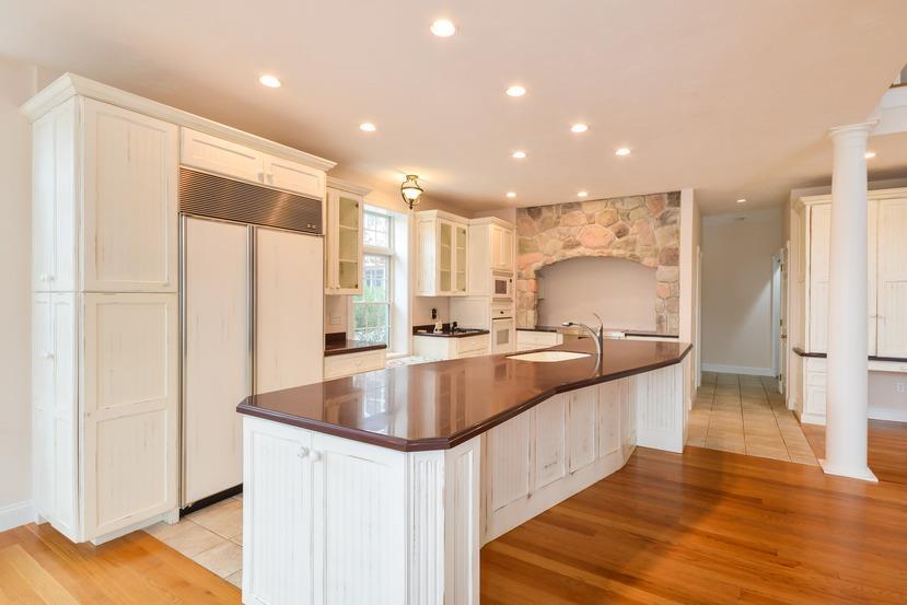 113 James Circle Mashpee, MA 02649 - Photo 4 of 29 a large kitchen with stainless steel appliances a large counter top a stove and a refrigerator