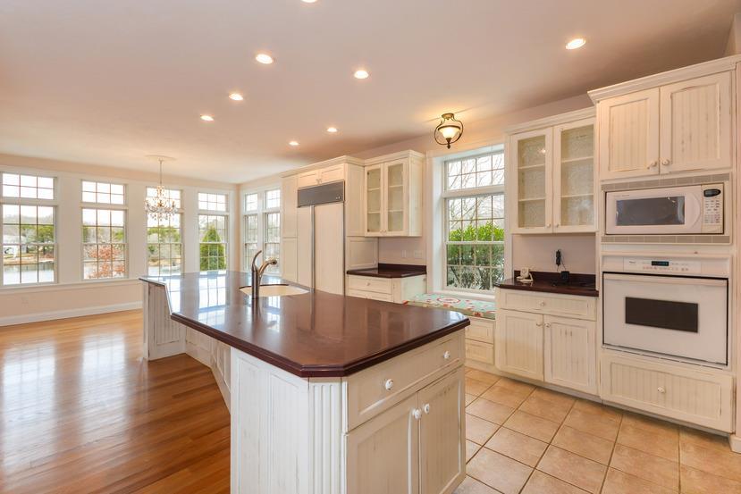 113 James Circle Mashpee, MA 02649 - Photo 5 of 29 a large kitchen with granite countertop a stove top oven a sink a dining table and chairs
