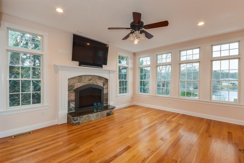 113 James Circle Mashpee, MA 02649 - Photo 8 of 29 a living room with a flat screen tv and a fireplace