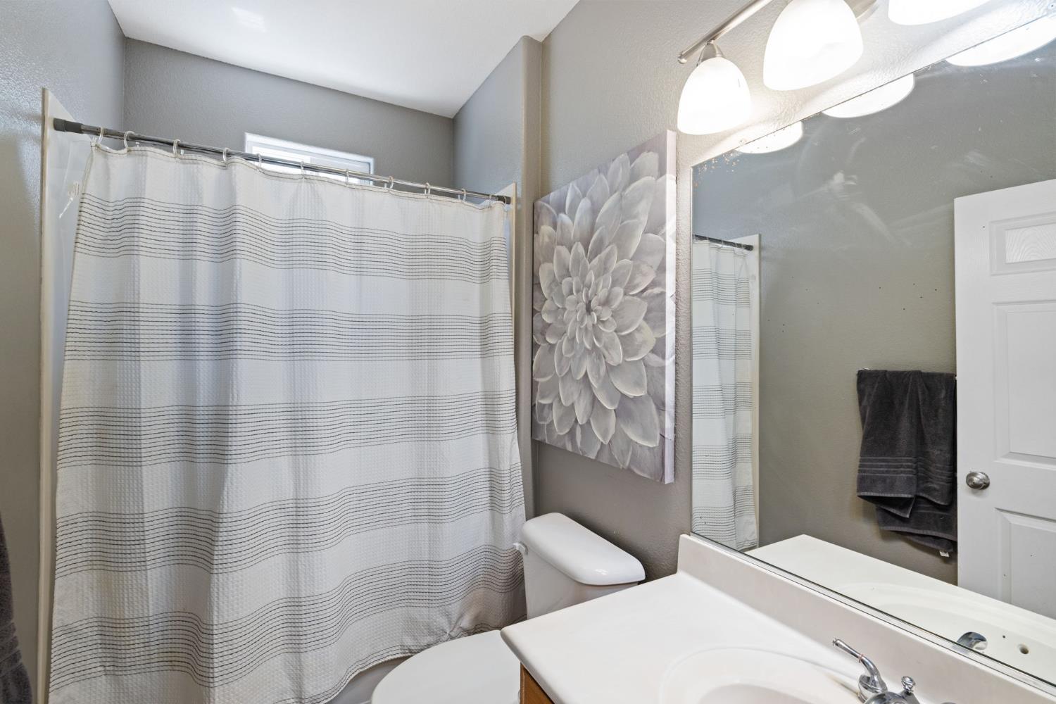 562 Ranger Street Oakdale, CA 95361 - Photo 11 of 63 Full downstairs bathroom featuring vanity and toilet