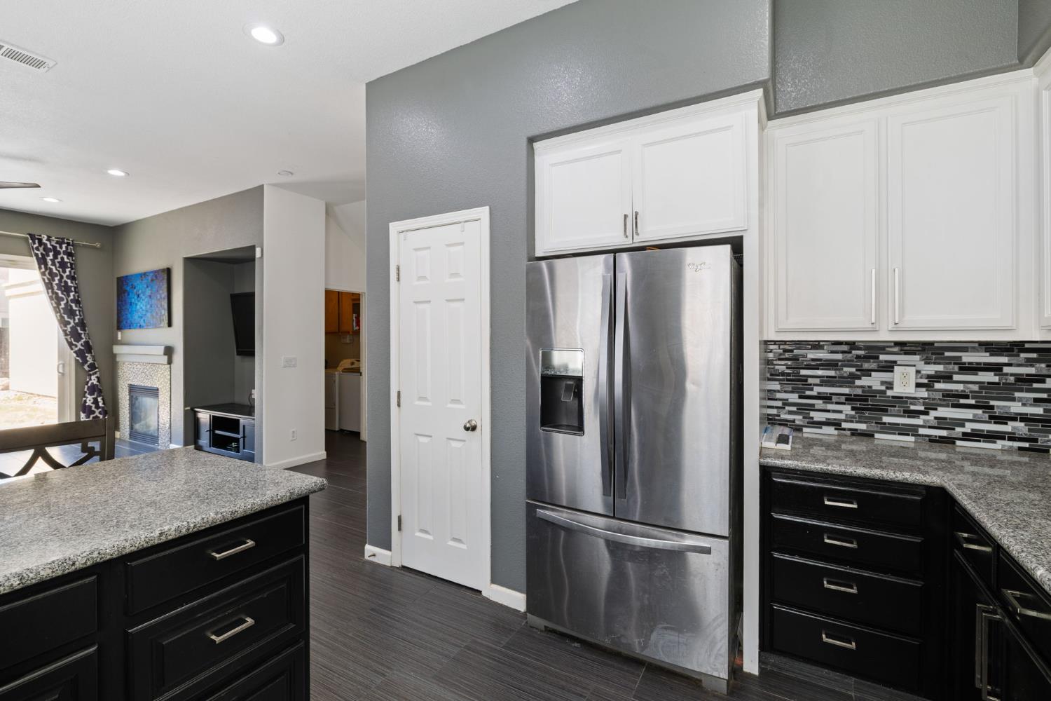 562 Ranger Street Oakdale, CA 95361 - Photo 25 of 63 kitchen showing stainless steel fridge with ice dispenser, granite countertops, and tile flooring