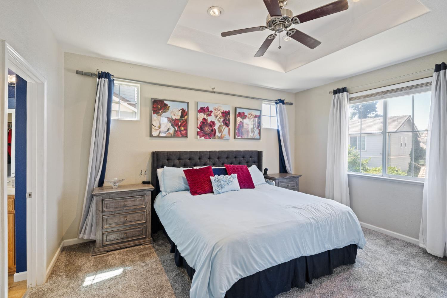 562 Ranger Street Oakdale, CA 95361 - Photo 30 of 63 Master bedroom featuring a raised ceiling, ceiling fan and cam lights.