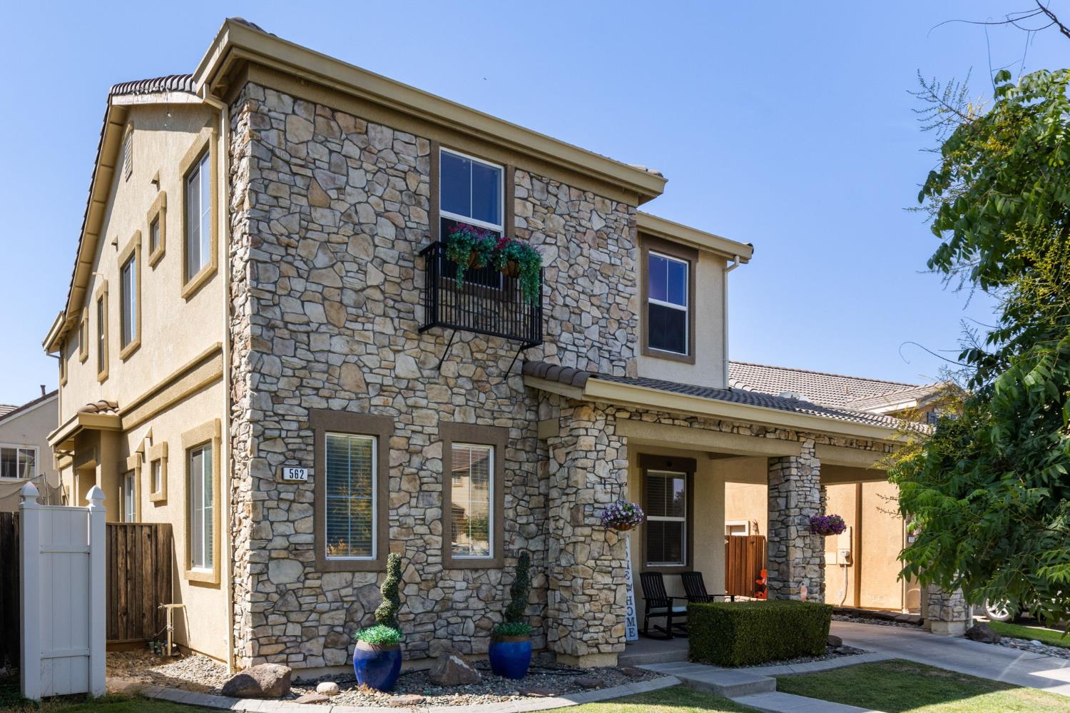 562 Ranger Street Oakdale, CA 95361 - Photo 4 of 63 view of front of property featuring stone siding, stucco siding, and a porch