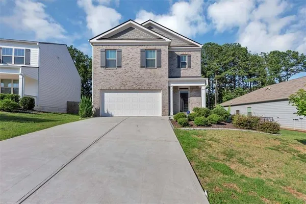 a front view of a house with a yard
