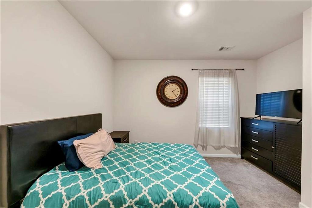 3737 Makeover Court Atlanta, GA 30349 - Photo 15 of 34 a bedroom with a bed and a television
