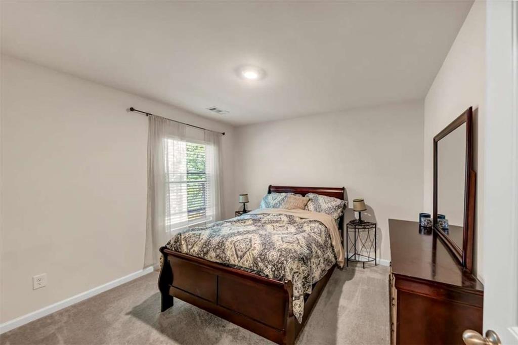 3737 Makeover Court Atlanta, GA 30349 - Photo 20 of 34 a bed sitting in a bedroom next to a window