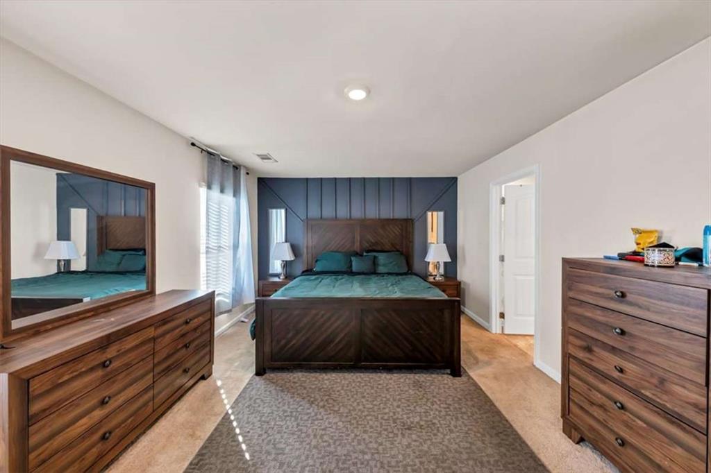 3737 Makeover Court Atlanta, GA 30349 - Photo 27 of 34 a bedroom with a bed and a dresser