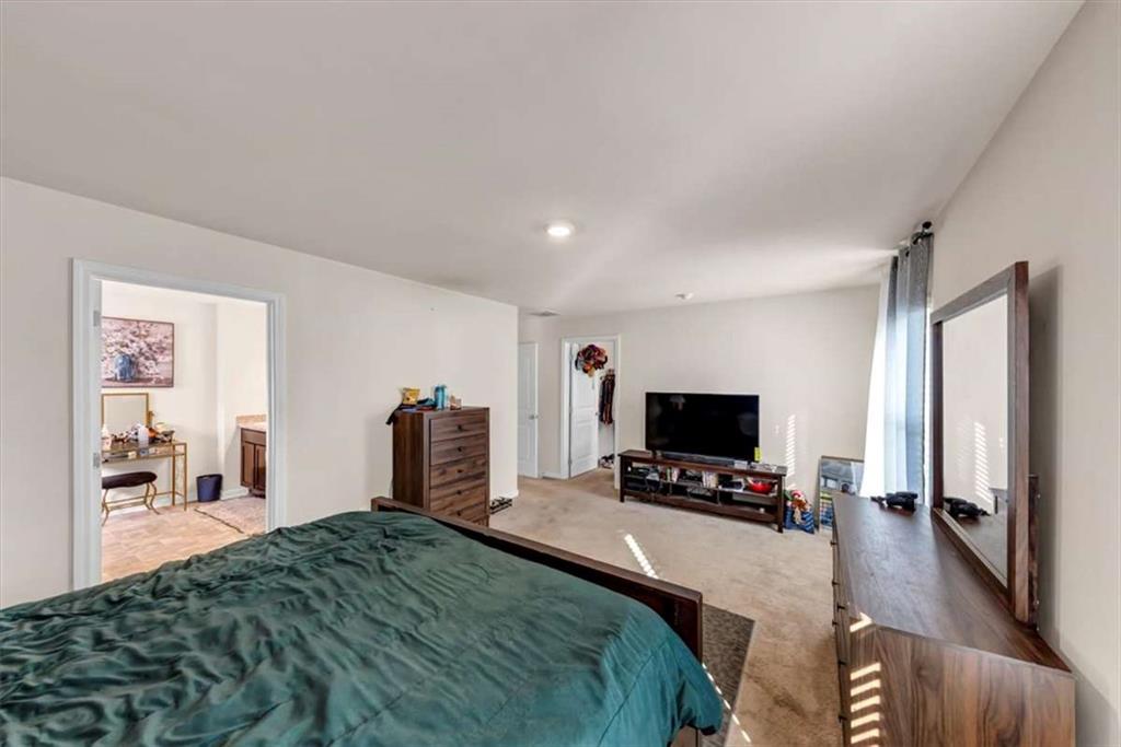 3737 Makeover Court Atlanta, GA 30349 - Photo 28 of 34 a bedroom with a bed a tv and wooden floor