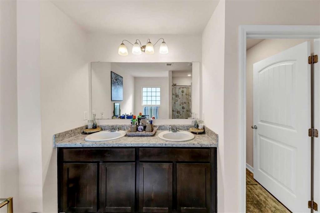 3737 Makeover Court Atlanta, GA 30349 - Photo 30 of 34 a bathroom with a sink and a mirror