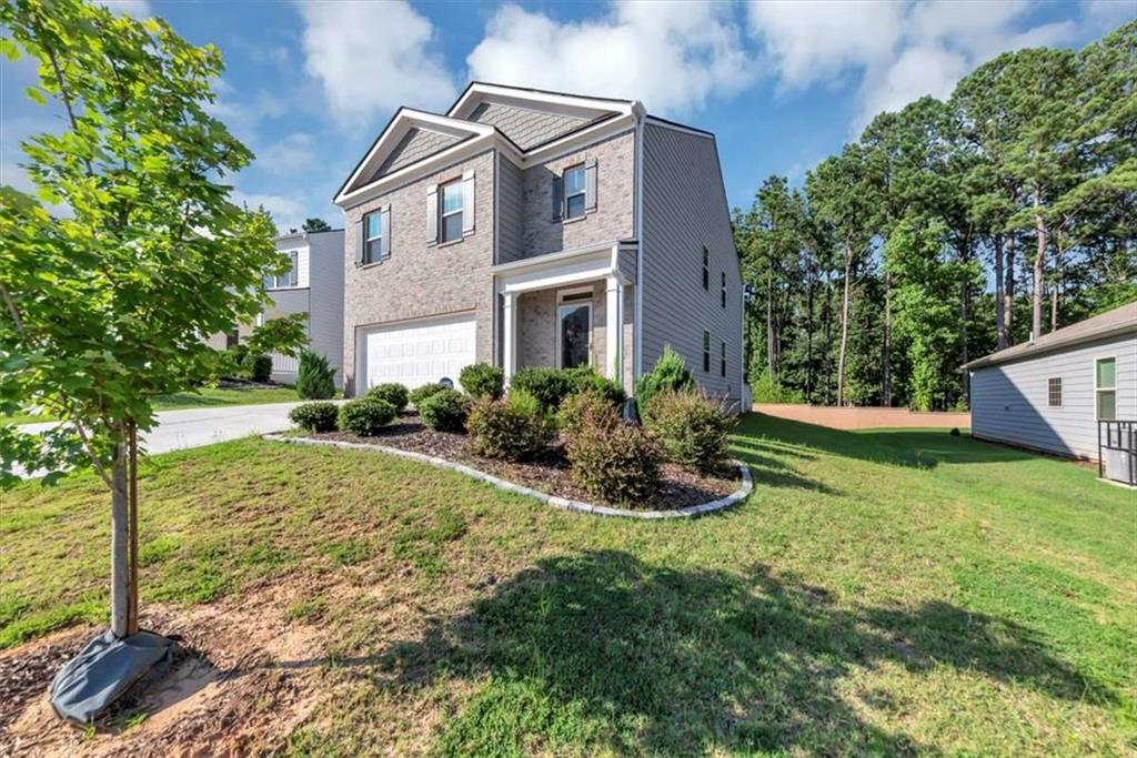 3737 Makeover Court Atlanta, GA 30349 - Photo 3 of 34 a front view of house with yard and trees