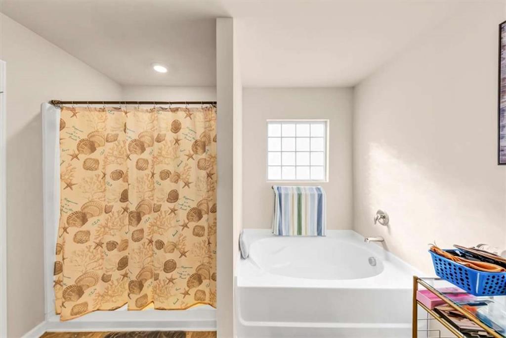 3737 Makeover Court Atlanta, GA 30349 - Photo 31 of 34 a bathroom with a bathtub and a shower