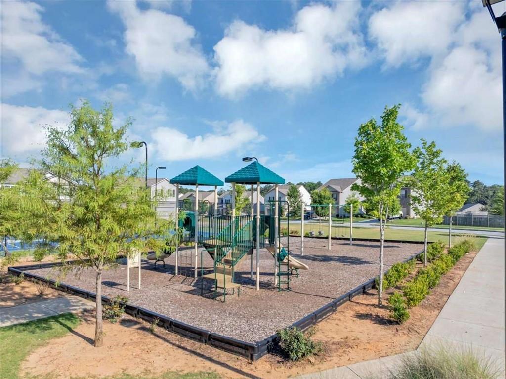 3737 Makeover Court Atlanta, GA 30349 - Photo 34 of 34 a backyard of a house with table and chairs