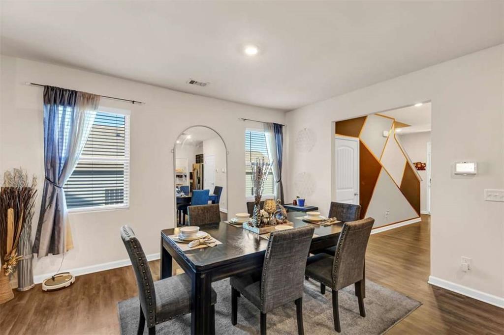 3737 Makeover Court Atlanta, GA 30349 - Photo 7 of 34 a view of a dining room with furniture and wooden floor