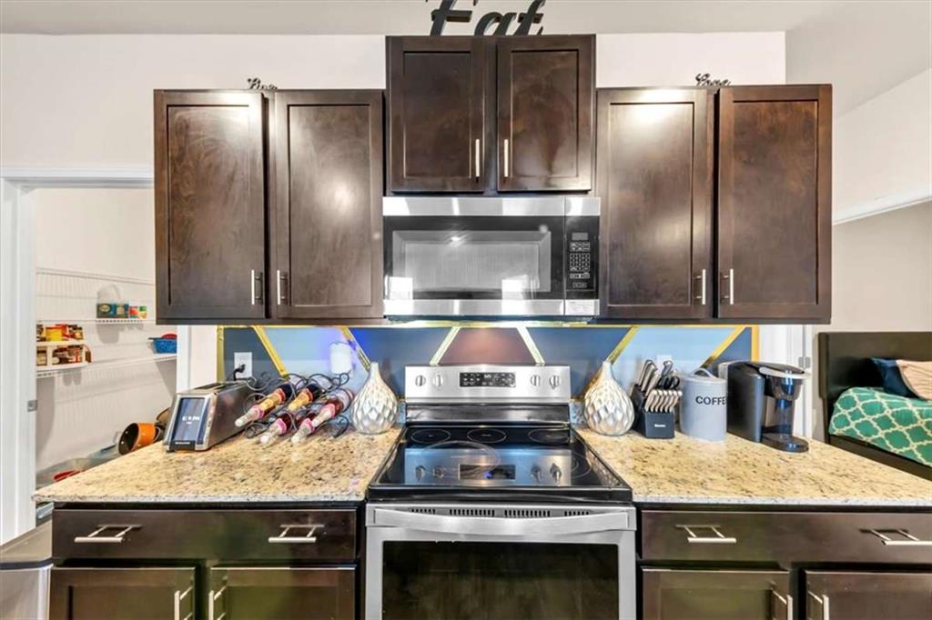 3737 Makeover Court Atlanta, GA 30349 - Photo 10 of 34 a kitchen with a stove and a refrigerator