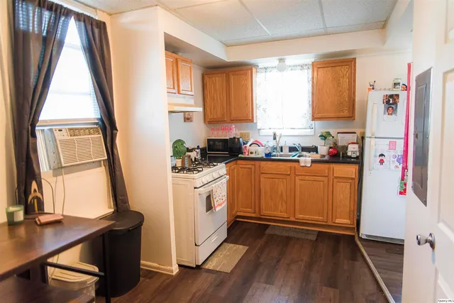 a kitchen with stainless steel appliances sink refrigerator microwave and window